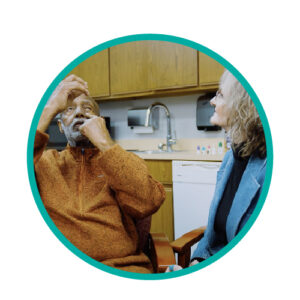 an individual watching her companion put eye drop medication in his eyes