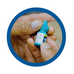 Checking the expiration date on an eye drop bottle